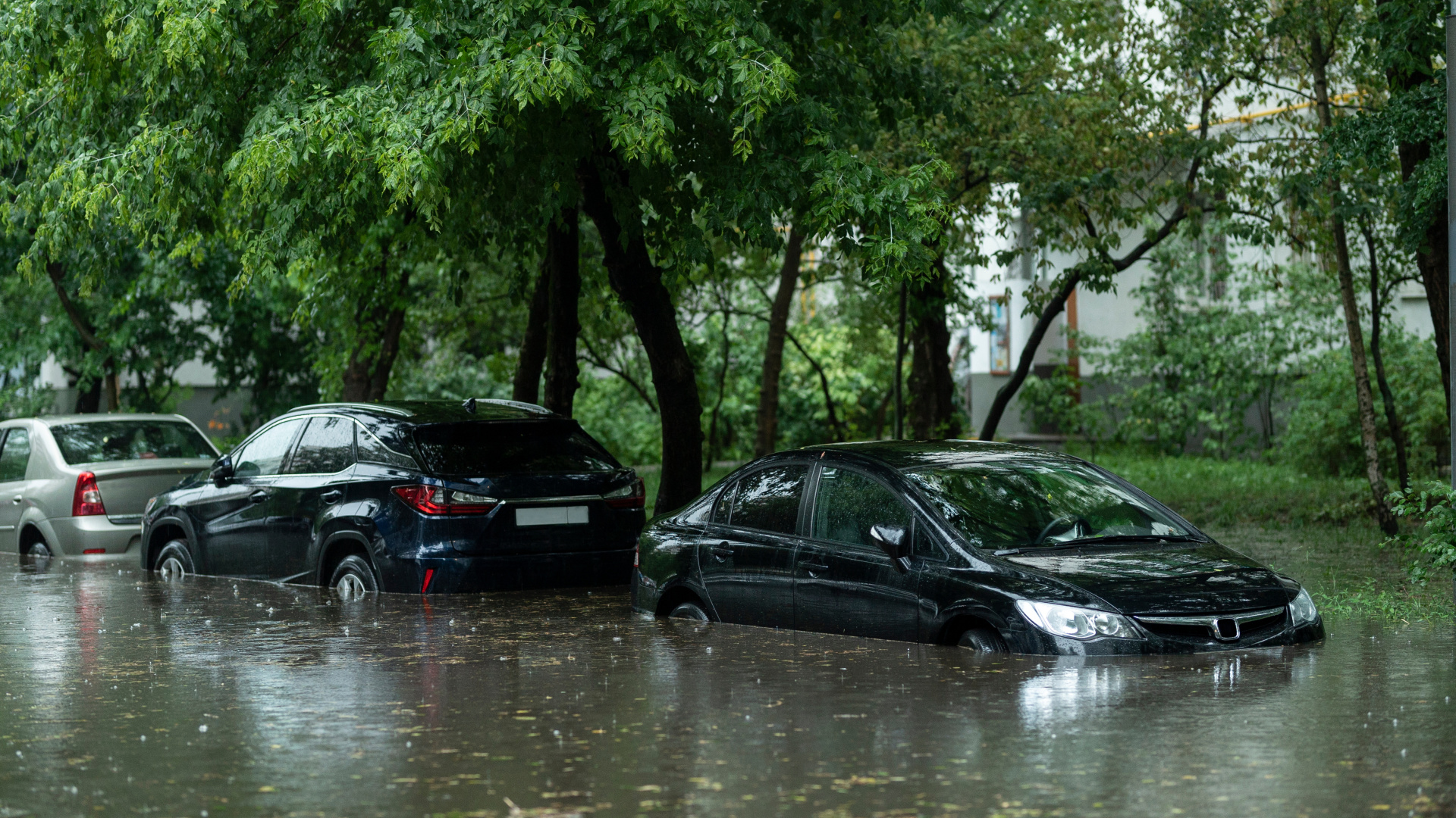 Flooded cars on the street of the city. Street after heavy rain. Water could enter the engine, transmission parts or other places. Disaster Motor Vehicle Insurance Claim Themed. Severe weather concept Flooded cars on the street of the city. Street after heavy rain. Water could enter the engine, transmission parts or other places. Disaster Motor Vehicle Insurance Claim Themed. Severe weather concept
