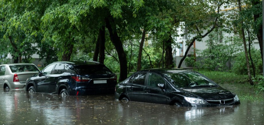 Flooded cars on the street of the city. Street after heavy rain. Water could enter the engine, transmission parts or other places. Disaster Motor Vehicle Insurance Claim Themed. Severe weather concept Flooded cars on the street of the city. Street after heavy rain. Water could enter the engine, transmission parts or other places. Disaster Motor Vehicle Insurance Claim Themed. Severe weather concept