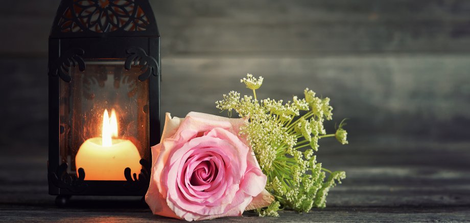 Memorial candle and flowers on wooden background Memorial candle and flowers on wooden background