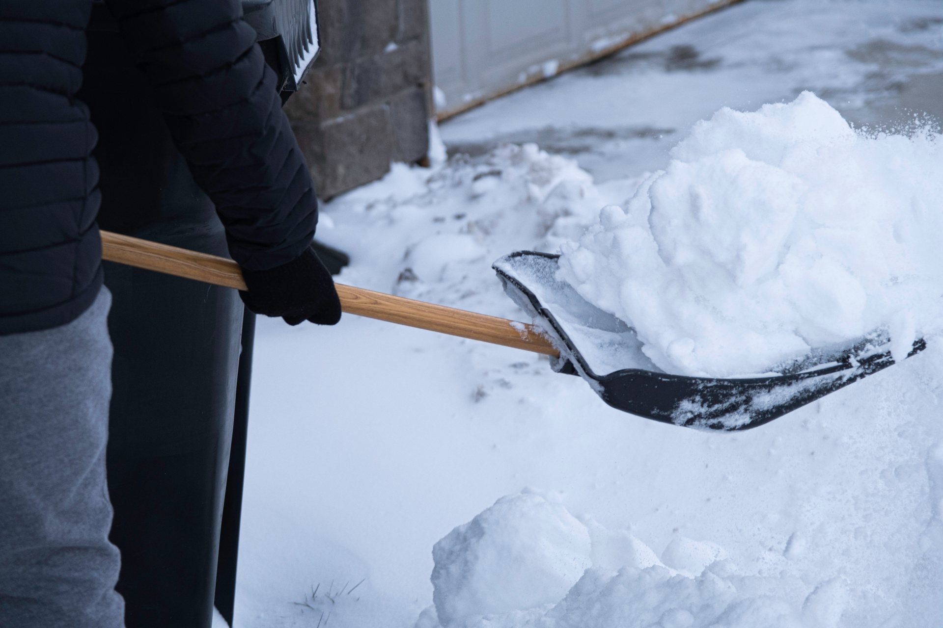 Clearing snow from driveway after heavy winter storm