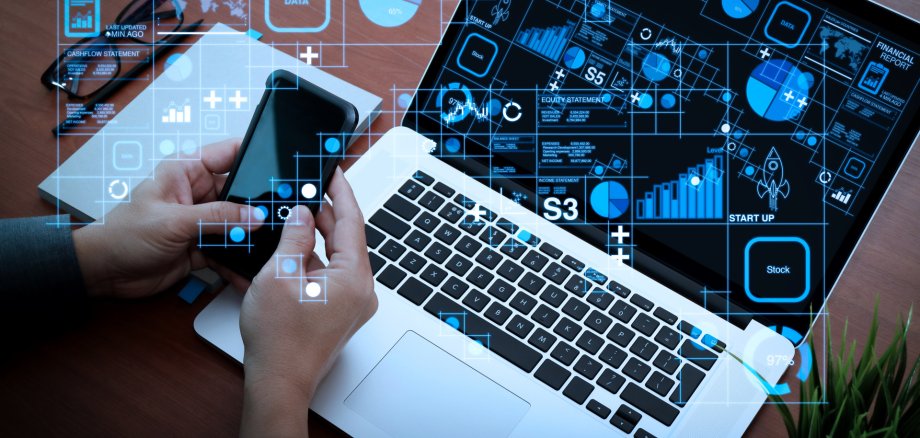 top view of businessman hand using on smart phone and laptop com