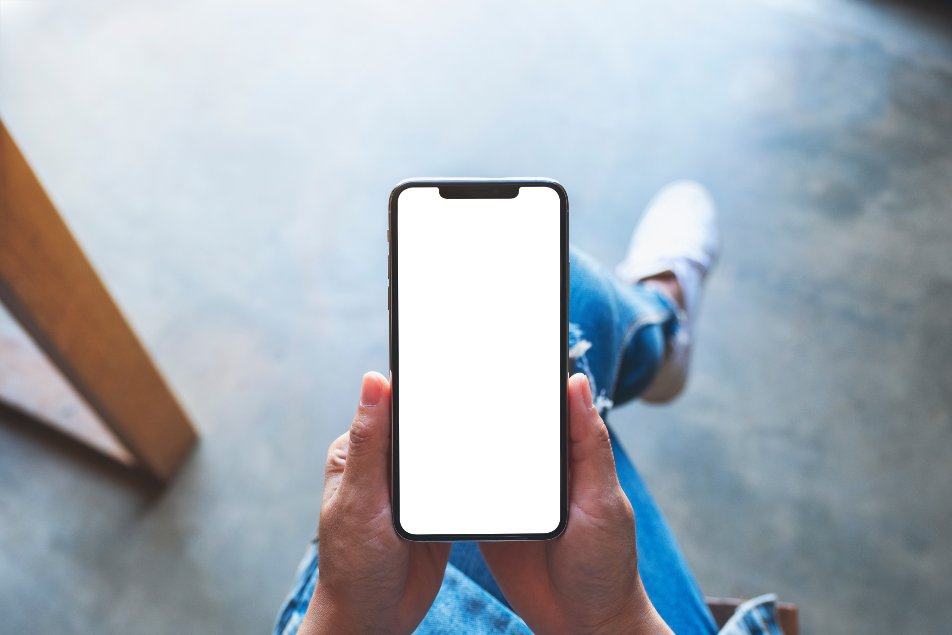 Top view mockup image of a woman holding black mobile phone with