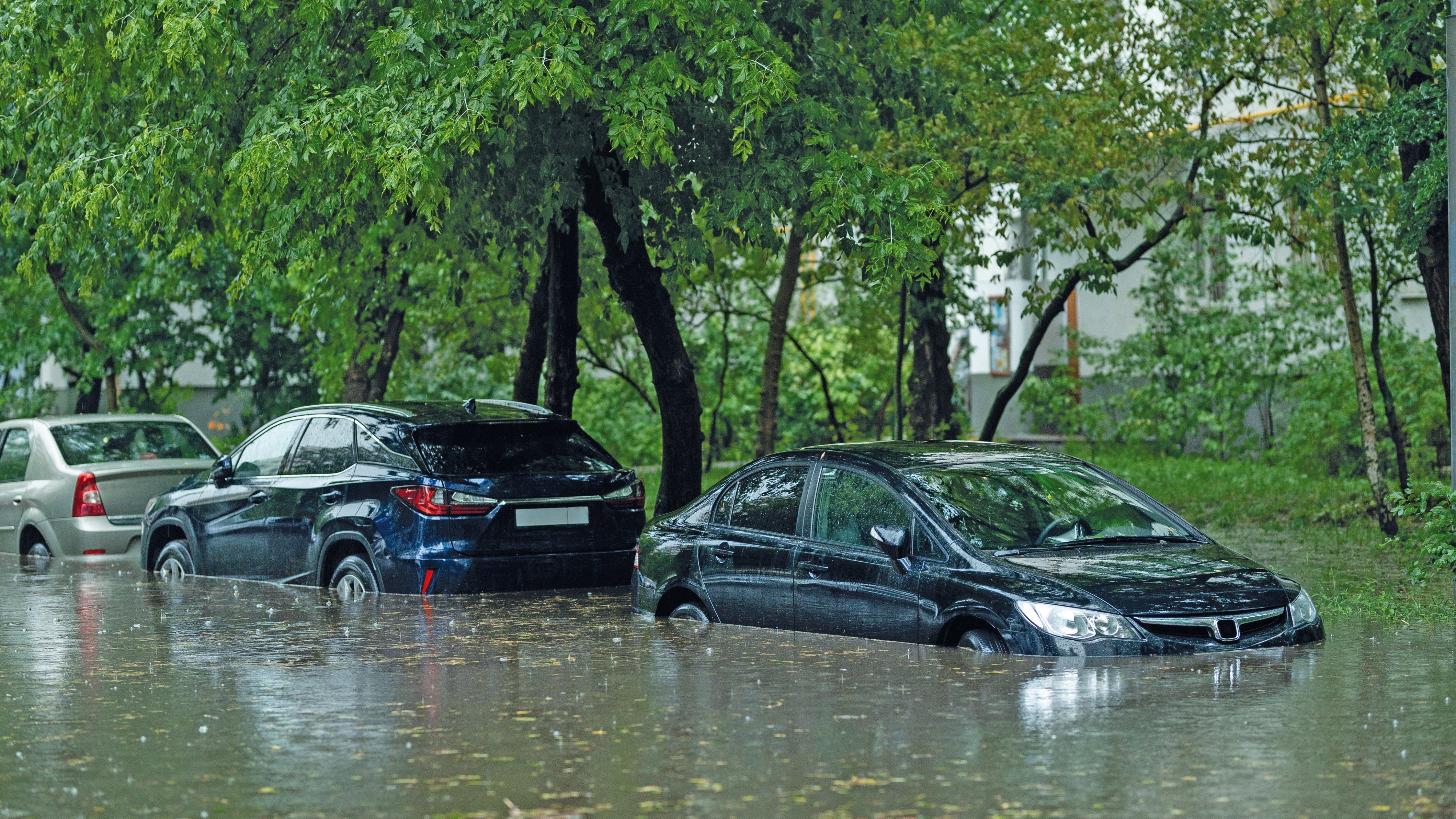 Flooded cars on the street of the city. Street after heavy rain. Water could enter the engine, transmission parts or other places. Disaster Motor Vehicle Insurance Claim Themed. Severe weather concept