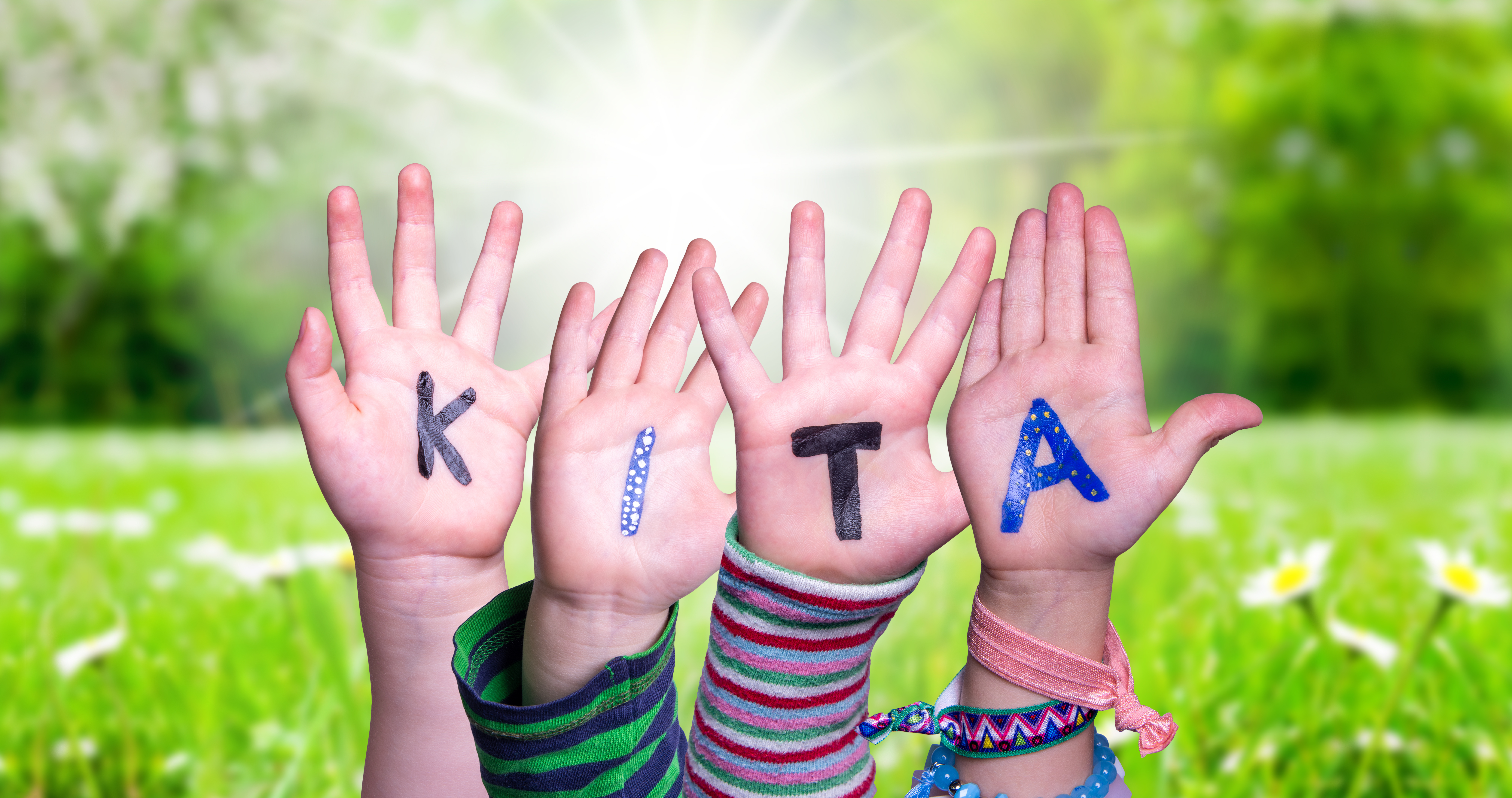 Children Hands Building Word KITA Means Kindergarden, Grass Meadow