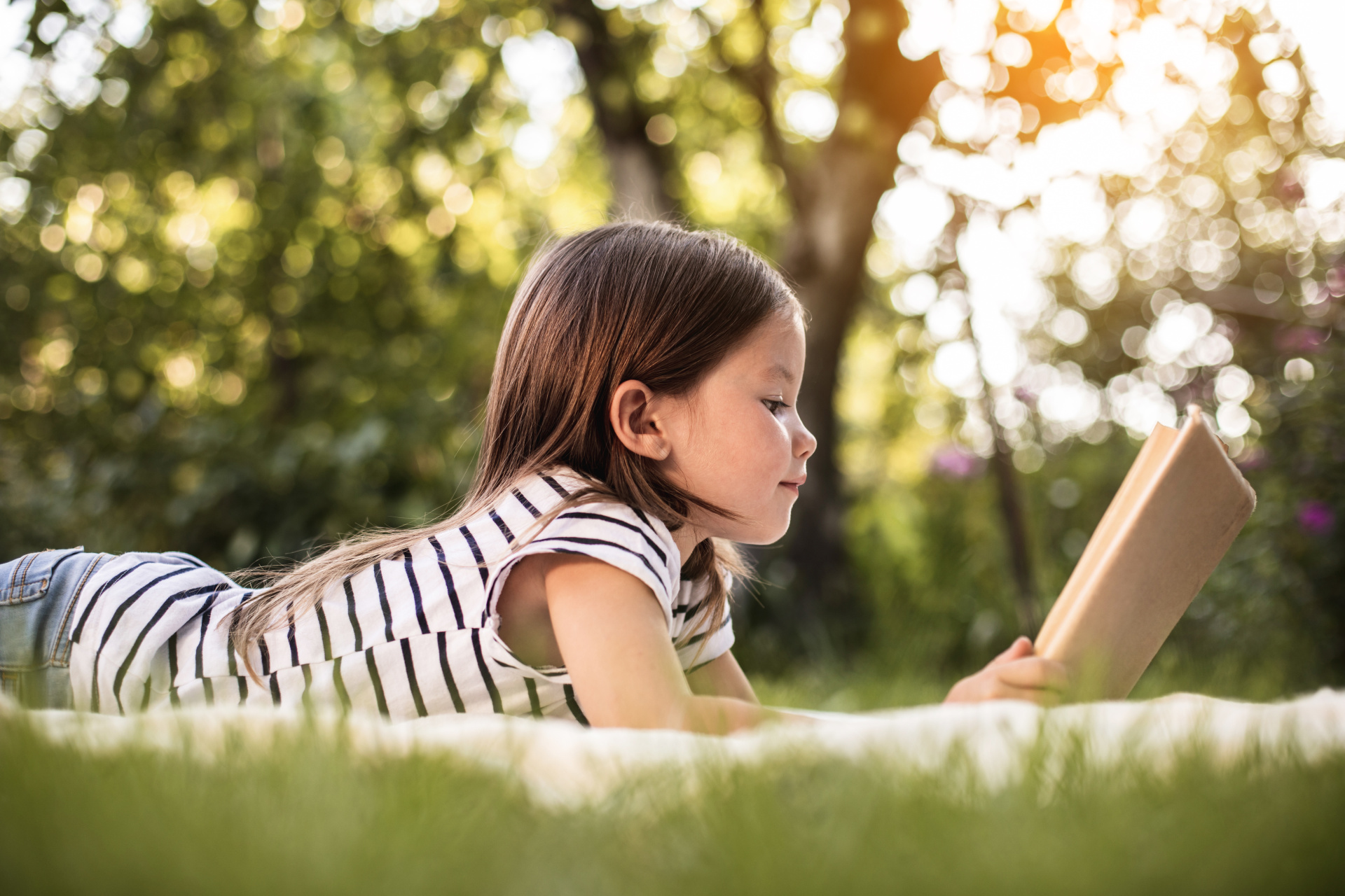 Little girl resting at park in summer Little girl resting at park in summer