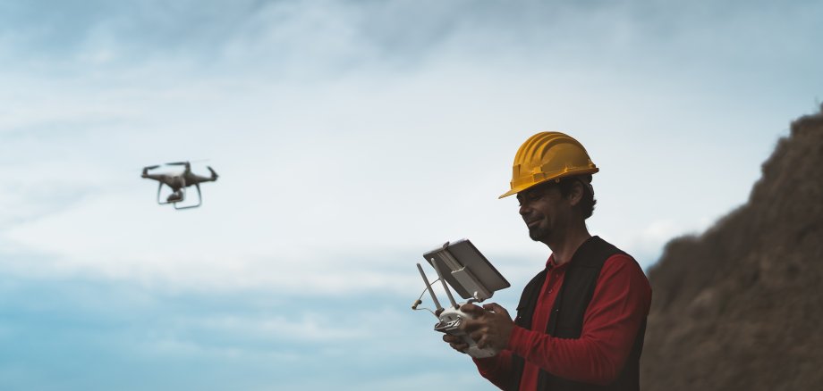 Male engineer doing inspection using drone - Technology and industrial concept