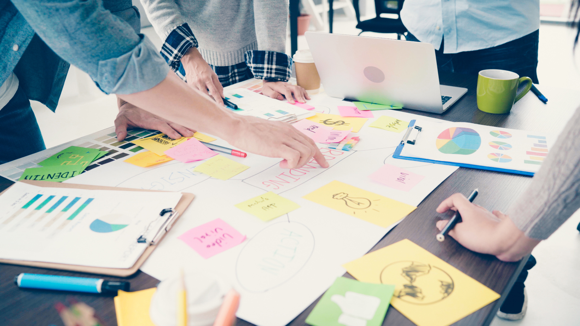 Group of casually dressed business people discussing ideas in the office. Creative professionals gathered at the meeting table for discuss the important issues of the new successful startup project.
