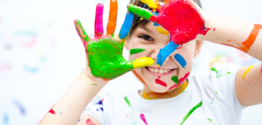 Cute girl playing with paints