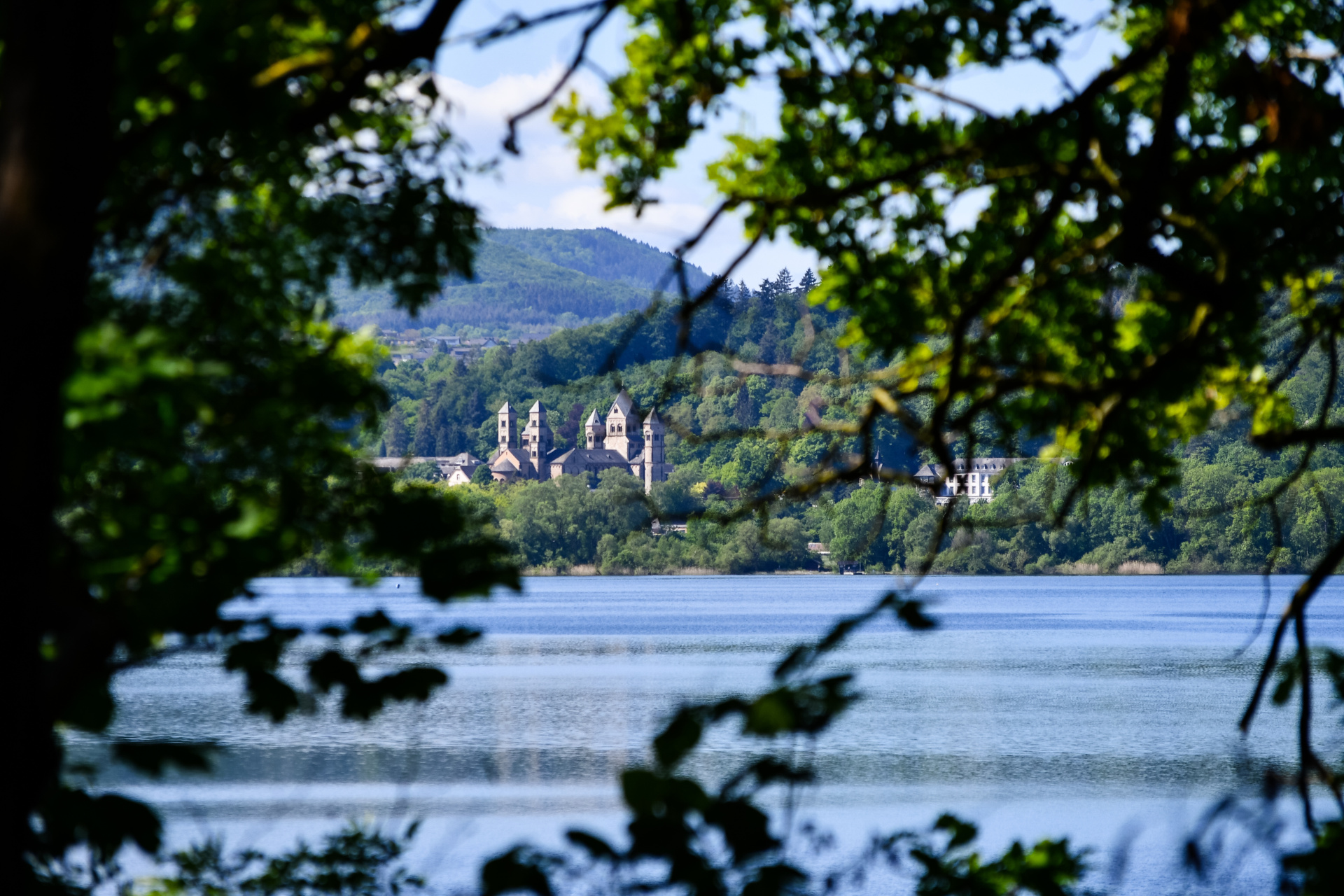 The Benedictine monastery in Maria Laach with the Laacher See on a beautiful spring day