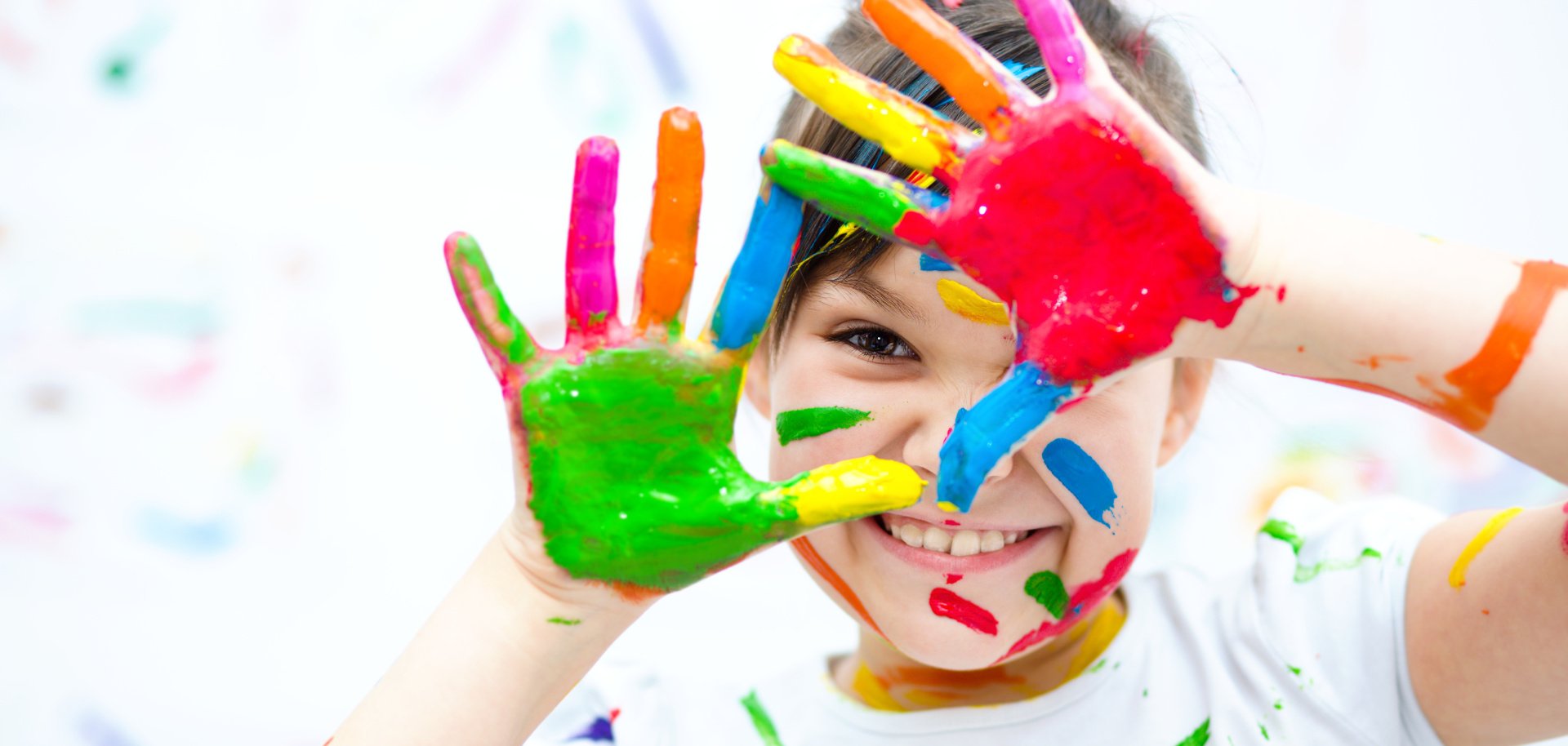 Cute girl playing with paints